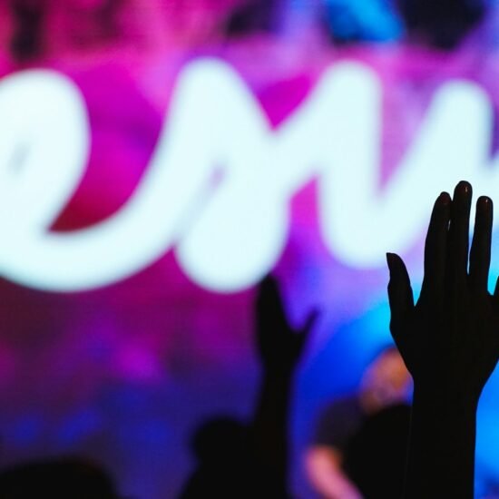 Silhouette of a raised hand at a worship concert — Goodbye Yesterday lyrics guide