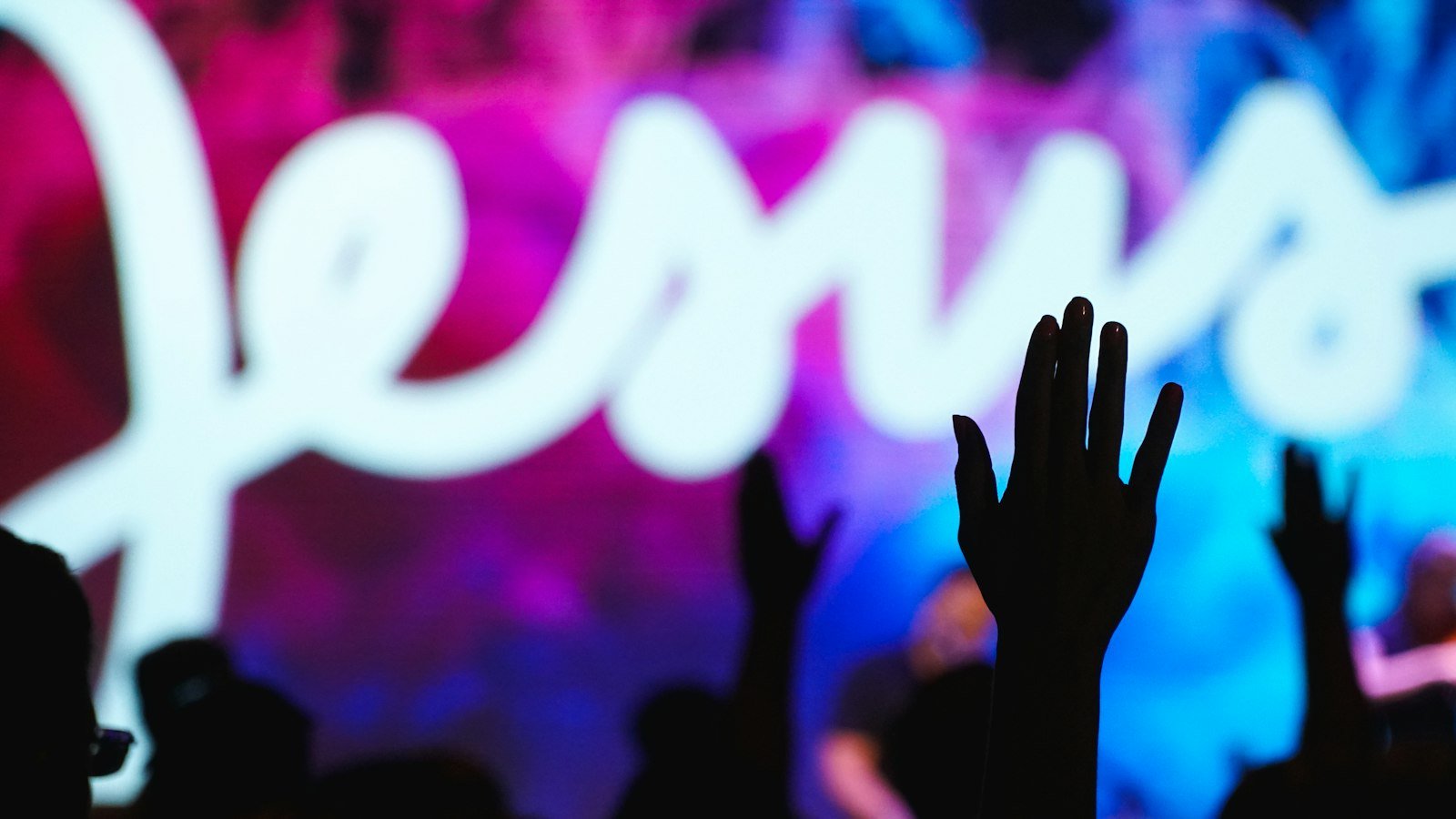 Silhouette of a raised hand at a worship concert — Goodbye Yesterday lyrics guide
