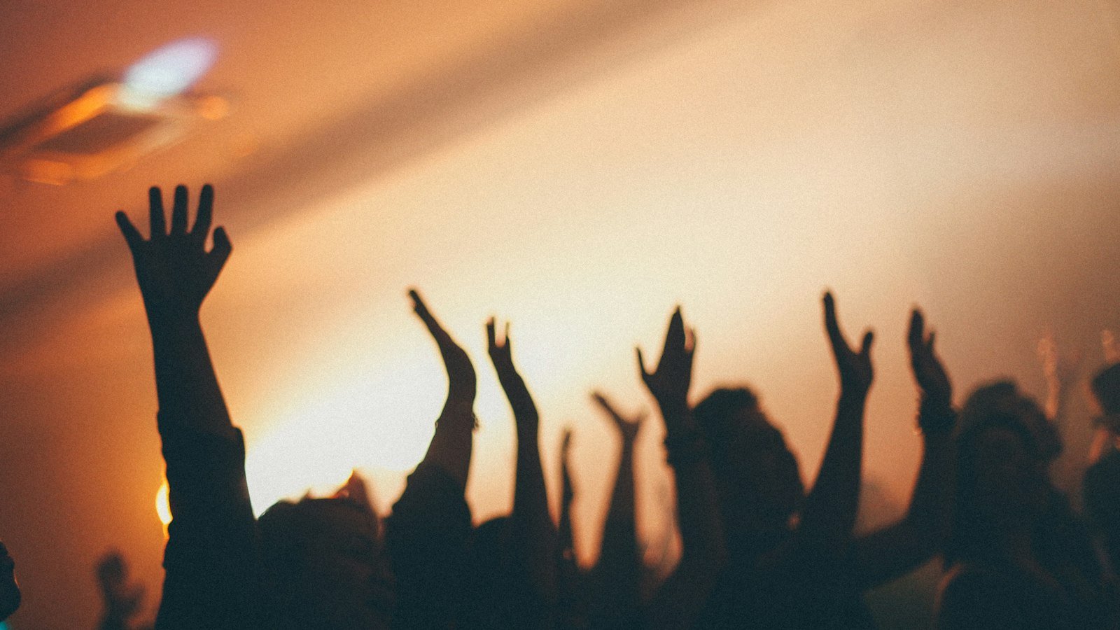 CeCe Winans Goodness of God lyrics — gospel concert crowd with raised hands in a dimly lit venue
