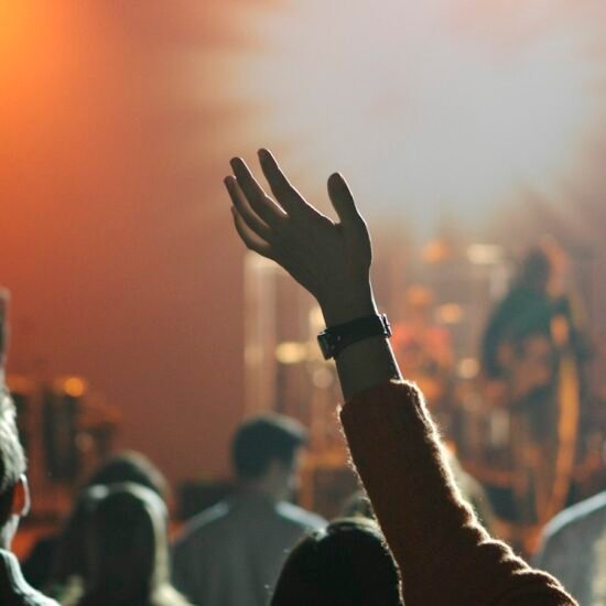 Worshipper raising a hand in praise — Victoria Orenze I Get Backing lyrics guide
