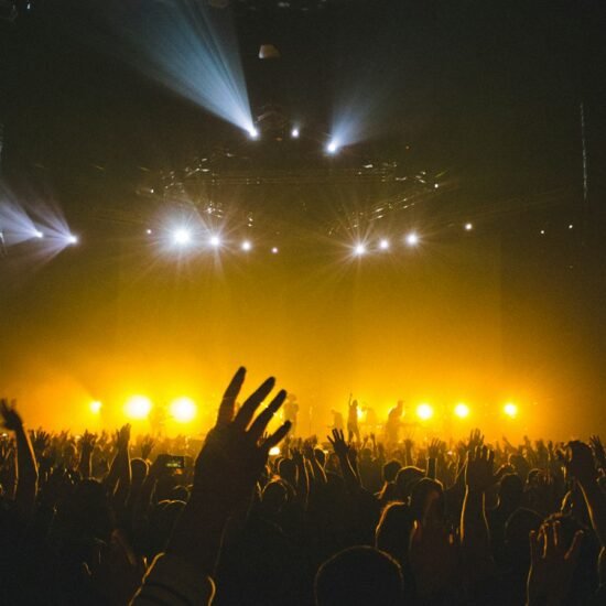 Worship concert crowd with raised hands — Maverick City Promises lyrics guide