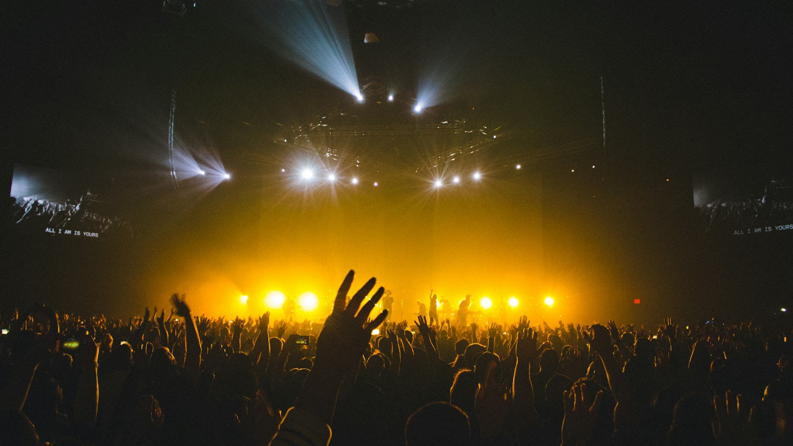 Worship concert crowd with raised hands — Maverick City Promises lyrics guide